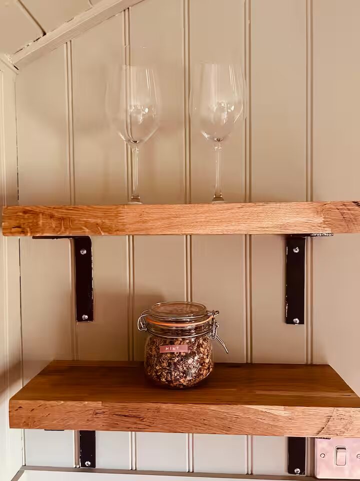 A shelf of books and candles — a personal corner at Clachamish House